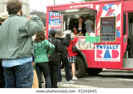 BROOKLYN, NEW YORK, MAY 22: Customers line up to purchase food from a food truck in Grand Army Plaza on May 22, 2011. Food trucks are a popular new source for fast, inexpensive, yet creative food.
