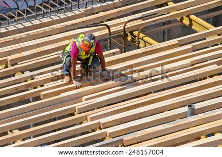 NEW YORK CITY, NEW YORK - APRIL 28, 2014: Construction worker at construction site near the High Line. Its popularity has led to dozens of new residential and commercial buildings along its route.