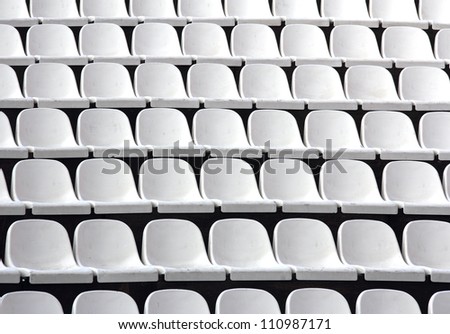 Gray plastic chairs at thetribune football stadium