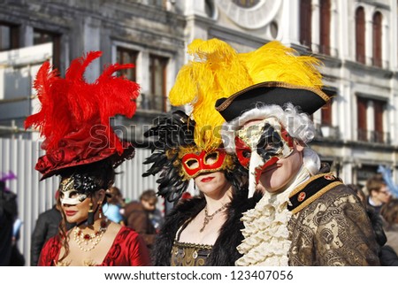 VENICE - 14 FEBRUARY: An unidentified man and two women masked in typical Venetian masks perform at the most famous European Carnival on February 14, 2010 in Venice.