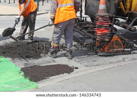 Workers On Asphalting Paver Machine During Road Street Repairing Works
