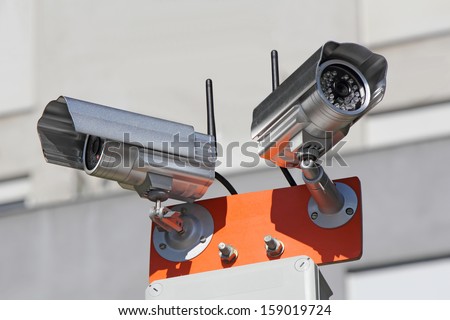 Two security cameras for monitoring building structure