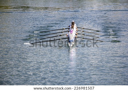 Rowers in eight-oar rowing boats on the tranquil lake