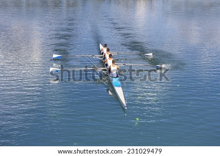 Rowers in four-oar rowing boats on the tranquil lake