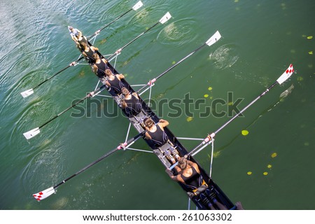 Boat coxed eight Rowers rowing on the tranquil lake