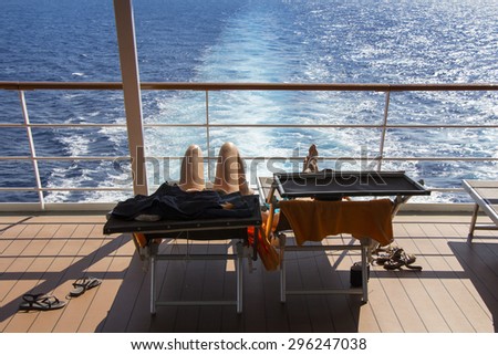Young couple sunbathing on the deck cruise ship