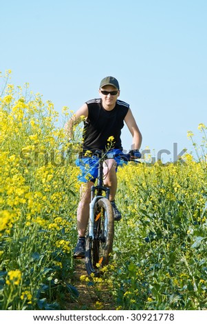 men on bike in flower field