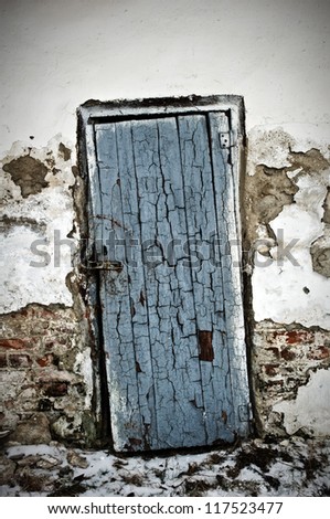 old locked door on ruined wall