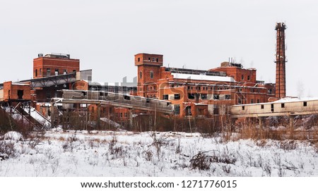 Old ruined factory construction in winter time. Urban exploration photography