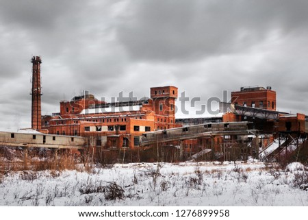 Old ruined factory construction in winter time. Urban exploration photography