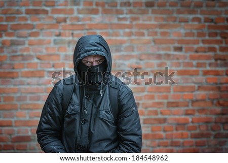 man in mask on wall background