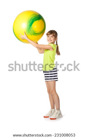 girl with yellow ball doing exercises on a white background