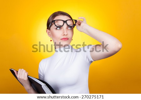 Portrait of a surprised woman. Woman in glasses with documents surprised. Lookup lifting points