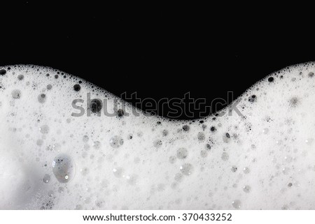 Foam bubbles abstract black background. Detergent