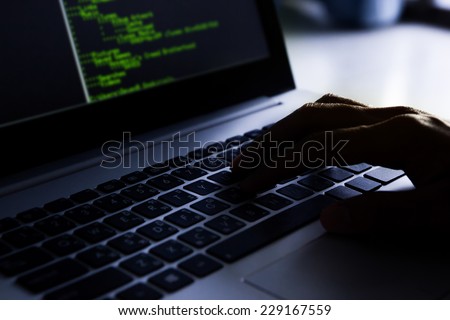 Hacker using laptop.