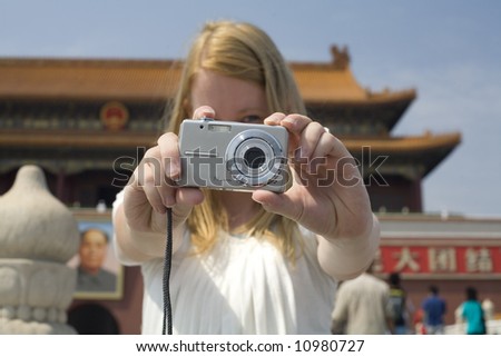 Girl outside Forbidden City taking a photo