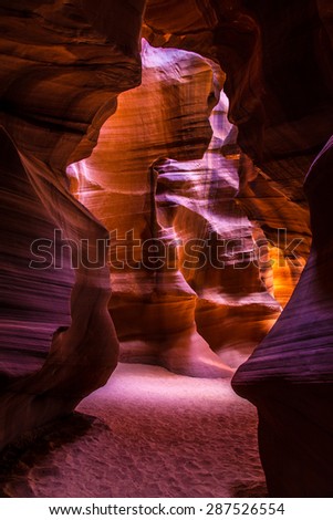 Sunlight reflects vivid colors into a deep canyon in Arizona.