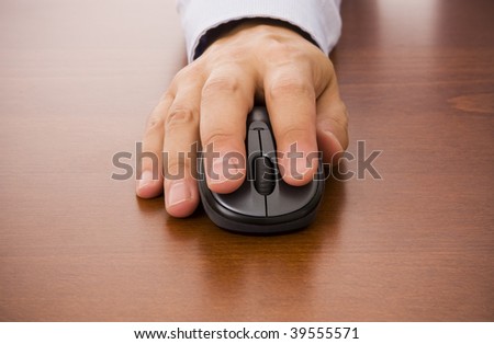 Close-up of a male hand clicking on a wireless mouse