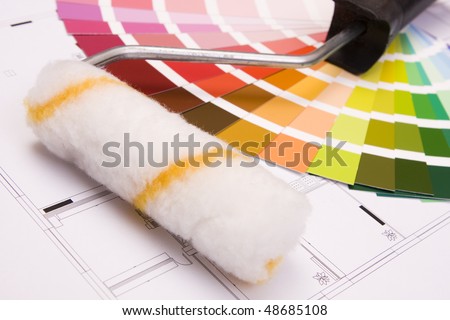 Color samples for selection and a a painter´s roll with house plan on background