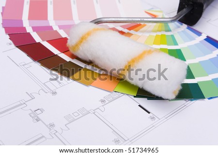 Color samples for selection and a a painterÂ´s roll with house plan on background