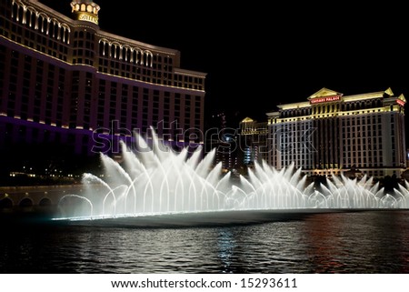 LAS VEGAS, NV - JULY 19: The iconic Fountains of Bellagio dance to the Sinatra\'s Fly Me To The Moon July 19, 2008 in Las Vegas, NV. Fountains of Bellagio can send water as high as 250 ft in the air.