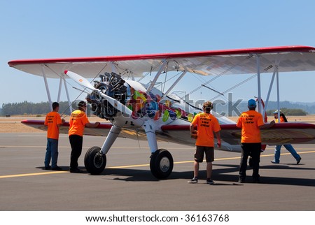 SANTA ROSA, CA - AUGUST 16: Crew prepares the Boeing Stearman biplane for the flight at Wings Over Wine Country airshow, August 16, 2009, Santa Rosa, CA.