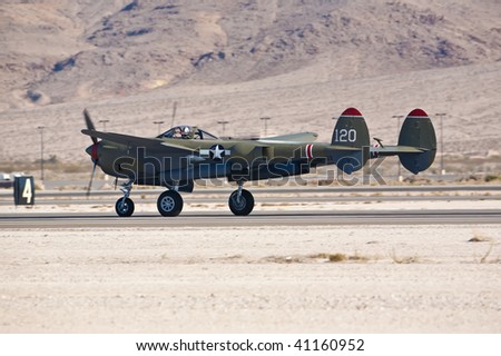 NELLIS AFB, LAS VEGAS, NV - NOVEMBER 14: Vintage Lockheed P-38 Lightning WWII-era fighter aircraft lands after performing at Aviation Nation 2009 on November 14, 2009 in Nellis AFB, Las Vegas, NV