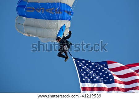 NELLIS AFB, LAS VEGAS, NV - NOVEMBER 14: A USAFA Wings of Blue Parachute Team jumper lands with US flag at Aviation Nation 2009 on November 14, 2009 in Nellis AFB, Las Vegas, NV