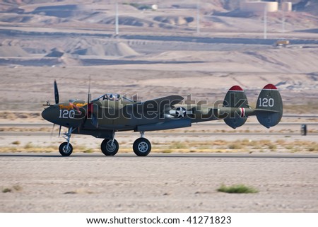 NELLIS AFB, LAS VEGAS, NV - NOVEMBER 14: Vintage Lockheed P-38 Lightning WWII-era fighter aircraft lands after performing at Aviation Nation 2009 on November 14, 2009 in Nellis AFB, Las Vegas, NV.