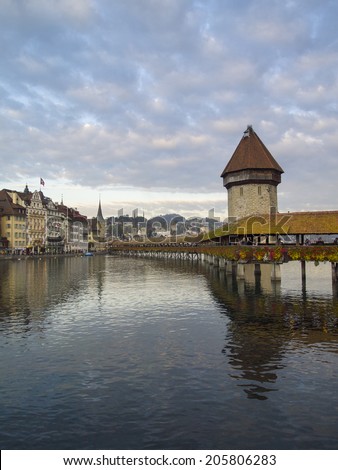 LUZERN, SWITZERLAND -OCTOBER 24, 2011: Chapel Bridge with Reuss River on October 24, 2011 in Lucern, Switzerland. The bridge was restored in 2002 after the terrible fire which broke out in 1993.