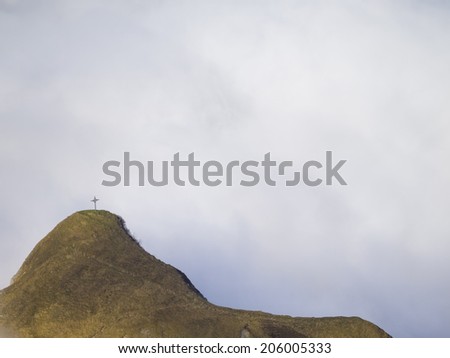 Cross on the summit of Klimsenhorn mountain, view from mount Pilatus, Lucerne, Switzerland.