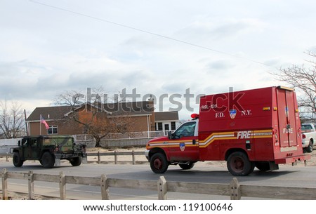 BREEZY POINT, NY - NOVEMBER 15:US National Guard and Fire Department vehicles moving to devastated area  in the aftermath of Hurricane Sandy on November 15, 2012 in Breezy Point, NY