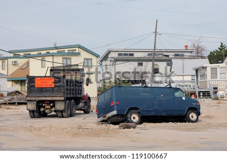 BREEZY POINT, NY - NOVEMBER 15: Destroyed van and construction truck  in the aftermath of Hurricane Sandy on November 15, 2012 in Breezy Point, NY