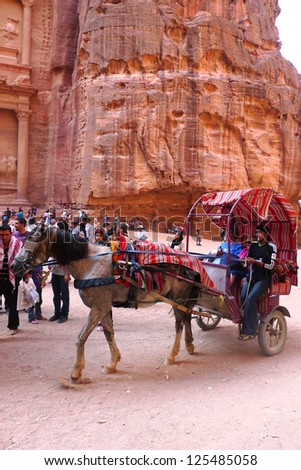 PETRA, JORDAN - NOVEMBER 16: Horse carriage in  front of the ancient Treasury on November 16, 2010 in Petra, Jordan.  Petra has been a UNESCO World Heritage Site since 1985
