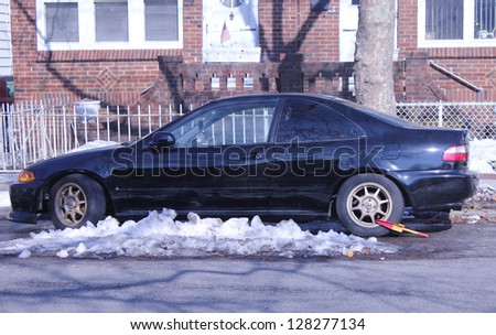 BROOKLYN,NEW YORK - FEBRUARY 14: Wheel lock on an illegally parked car in Brooklyn, NY on February 14, 2013. NYC started wheel lock program in January 2013.