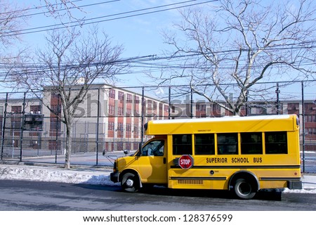 BROOKLYN, NEW YORK - FEBRUARY 14: School bus in front of public school in Brooklyn, NY on February 14, 2013. NYC School Bus Drivers union 1181 still on strike form January 16, 2013.