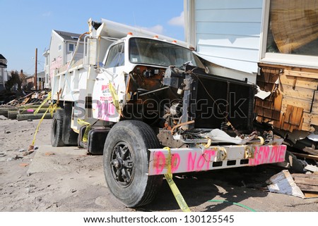 FAR ROCKAWAY, NY - FEBRUARY 28: Damaged truck in devastated area four months after Hurricane Sandy on February, 28, 2013 in Far Rockaway, NY