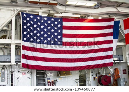 STATEN ISLAND, NEW YORK - MAY 29:Huge American flag inside the deck of US Navy destroyer during Fleet Week 2012 on May 29, 2012 in Staten Island, New York