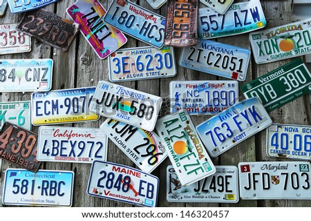BAR HARBOR, MAINE - JULY 6: Old car license plates on the wall in Bar Harbor on July 6, 2013. In the U.S., where each state issues plates, New York State has required plates since 1901