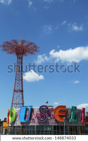 BROOKLYN, NEW YORK - JULY 30: Parachute jump tower and restored historical B&B carousel in Brooklyn on July 30, 2013. Jump tower has been called the \