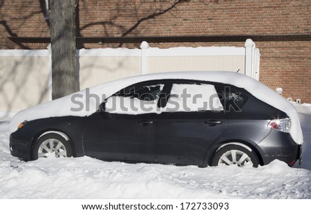 BROOKLYN, NEW YORK - JANUARY 22: Car under snow on January 22, 2014 in Brooklyn, NY after massive Winter Storm Janus strikes Northeast. Foot of snow hits NYC as Northeast reels from Winter Storm Janus