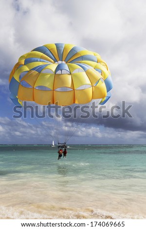 PUNTA CANA, DOMINICAN REPUBLIC - DECEMBER 31: Parasailing in a blue sky in Punta Cana on December 31, 2013. Parasailing is a popular recreational activity among tourists in Dominican Republic
