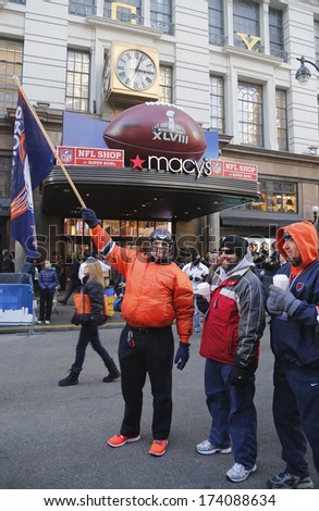 NEW YORK - JANUARY 30: Unidentified Denver Broncos fans in the front of Macy\'s Herald Square on Broadway during Super Bowl XLVIII week in Manhattan on January 30, 2014