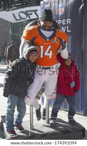 NEW YORK - JANUARY 30: Unidentified Denver Broncos fans taken photo with Seahawks team uniform on Broadway during Super Bowl XLVIII week in Manhattan on January 30, 2014