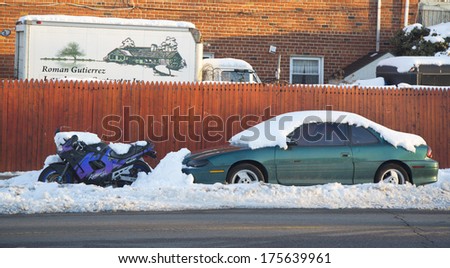 BROOKLYN, NEW YORK - FEBRUARY 6  Cars and motorcycle under snow on February 6, 2014 in Brooklyn, NY after massive winter storms strikes Northeast