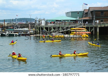 BAR HARBOR, MAINE - JULY 6: Tourists riding sea kayaks in Bar Harbor on July 6, 2013. Bar Harbor is a famous summer colony in the Down East region of Maine