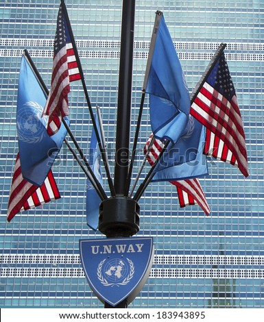 NEW YORK CITY - MARCH 20: United Nations and United States Flags in the front of UN Headquarter in New York on March 20, 2014