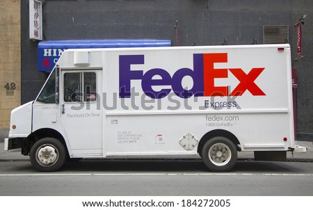 NEW YORK CITY - MARCH 20: FedEx Express truck in Manhattan on March 20, 2014. Fedex is one of largest package delivery companies worldwide with 300,000 employees USD 42.7 billion revenue (2012)