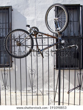 BROOKLYN, NEW YORK - MAY 1 Old bicycles locked to metal gate in Williamsburg, Brooklyn on May 1, 2014. Williamsburg is an influential hub of hipster culture, and the local art community
