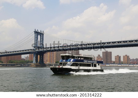 NEW YORK - JUNE 17: East River ferry boat rides under Manhattan Bridge on June 17, 2014. East River Ferry features service that connects Manhattan with various destinations in Brooklyn and Queens